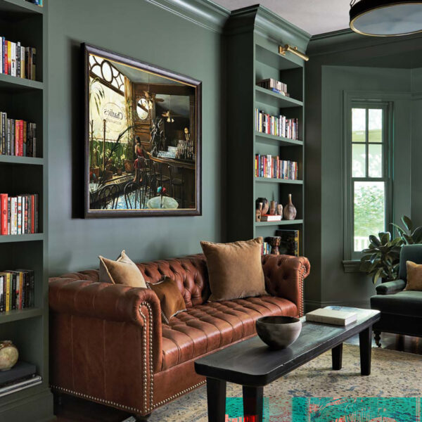A Wilmette Home Delivers On A Wish For A More Laid-Back Lifestyle transitional library with green walls and brown leather couch