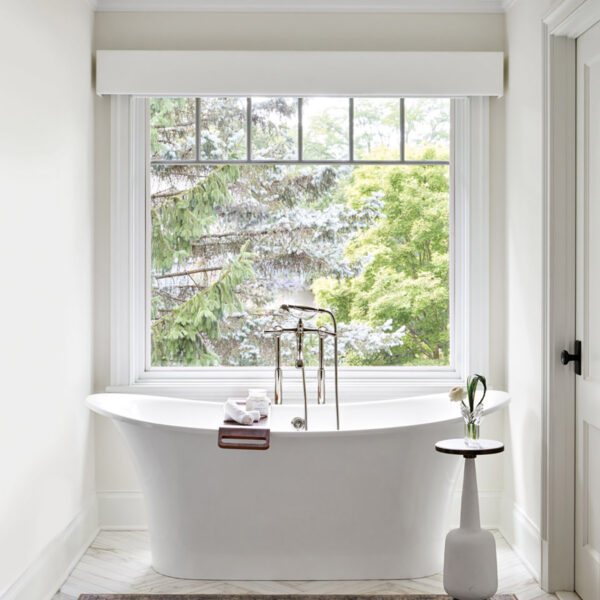 A Wilmette Home Delivers On A Wish For A More Laid-Back Lifestyle transitional bathroom features white standalone bathtub