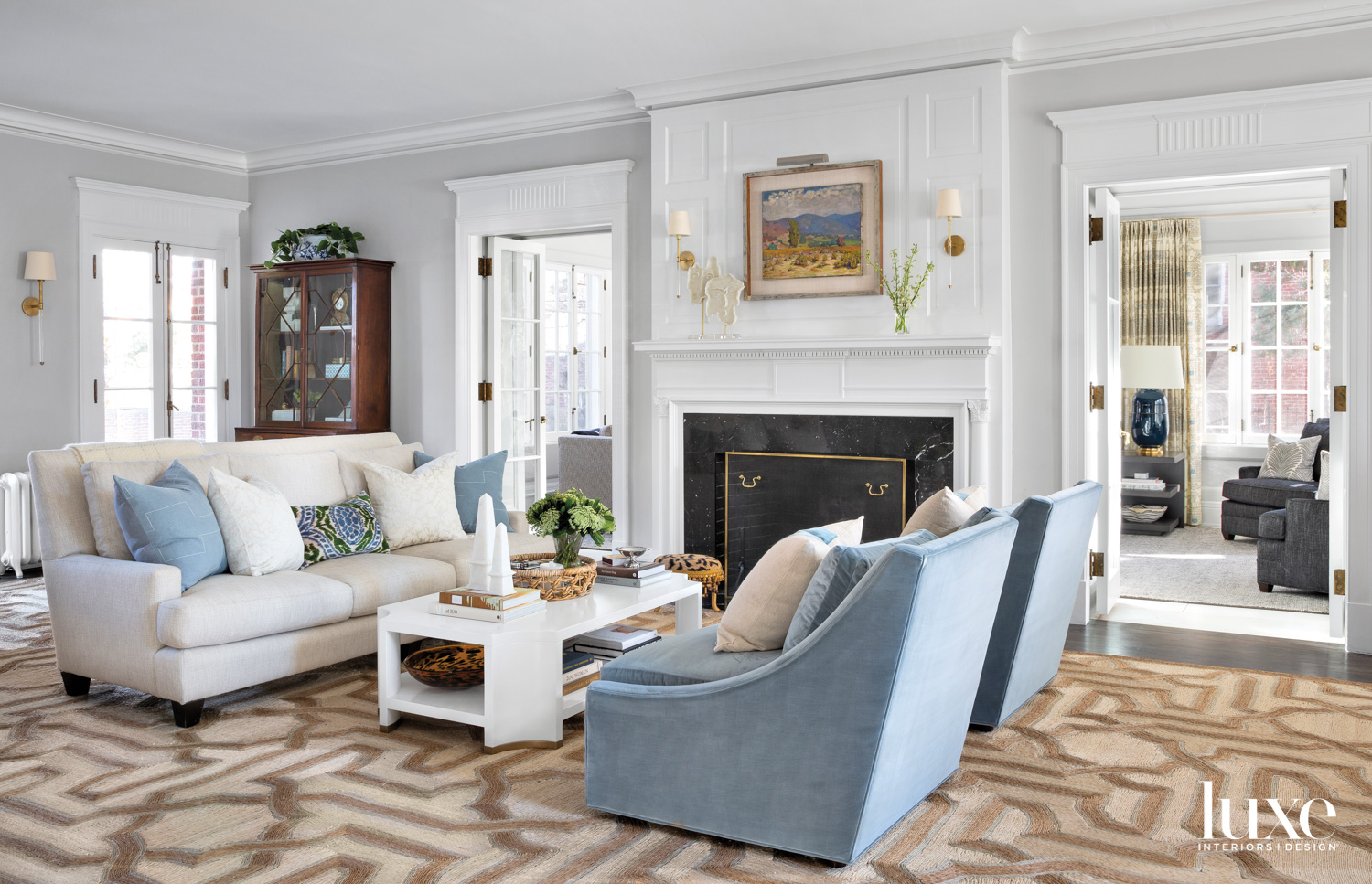 white living room with blue armchairs