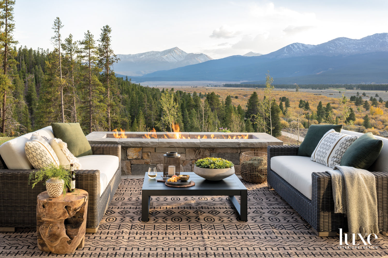 A patio has a fire pit and a view of the moutains.
