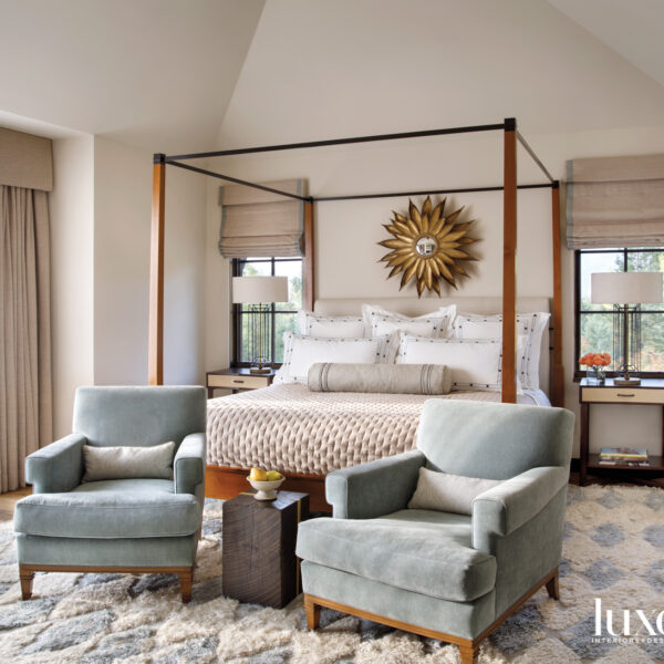 Joy Fills A Swiss Chalet-Inspired Colorado Home With Global Notes mountain-style guest bedroom features modern four-poster bed