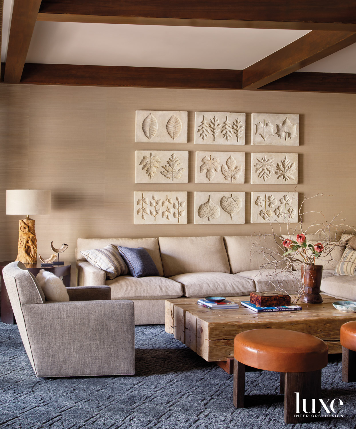 A family room has a series of leaf impressions as art.
