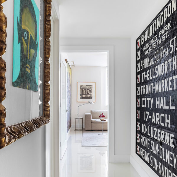 A Health-First Fort Lauderdale Haven Masters The Art Of The Pivot modern white hallway adorned with eclectic artwork