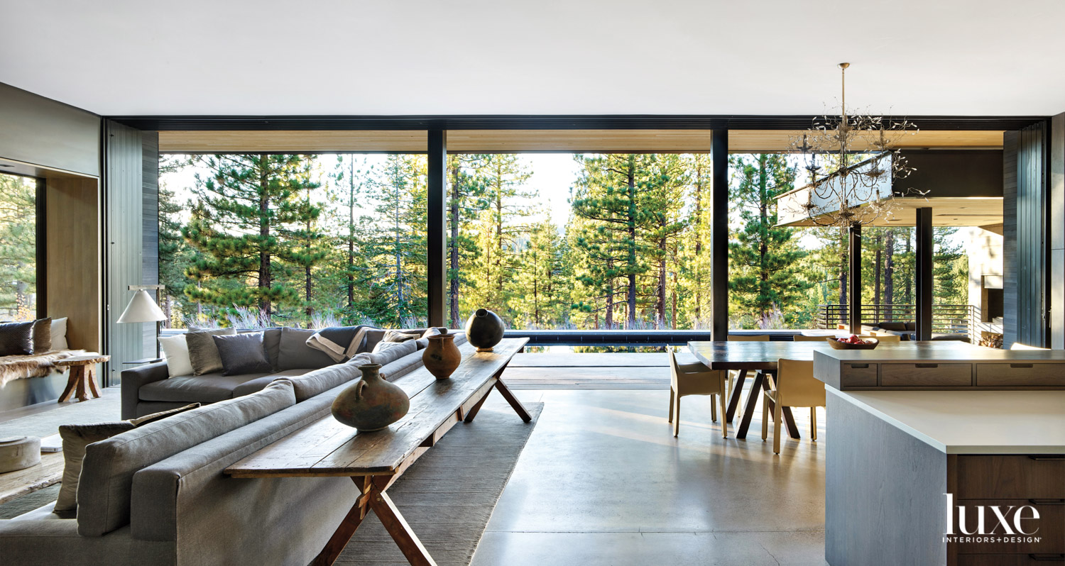A large wall of glass embraces a nature view.