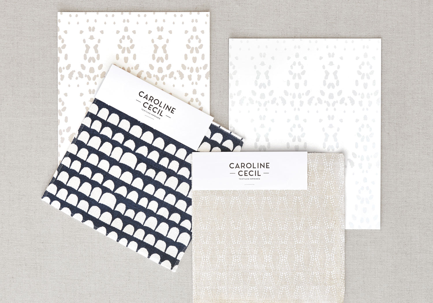 Four white, black and neutral patterned textile swatches.