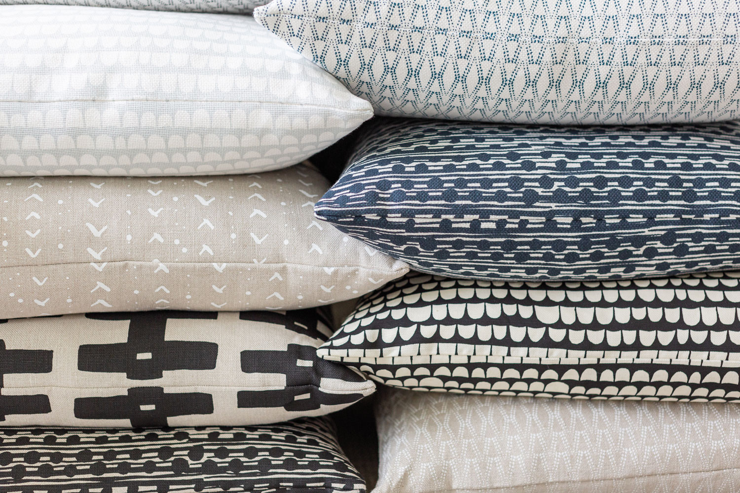 Blue, white and neutral patterned pillows.