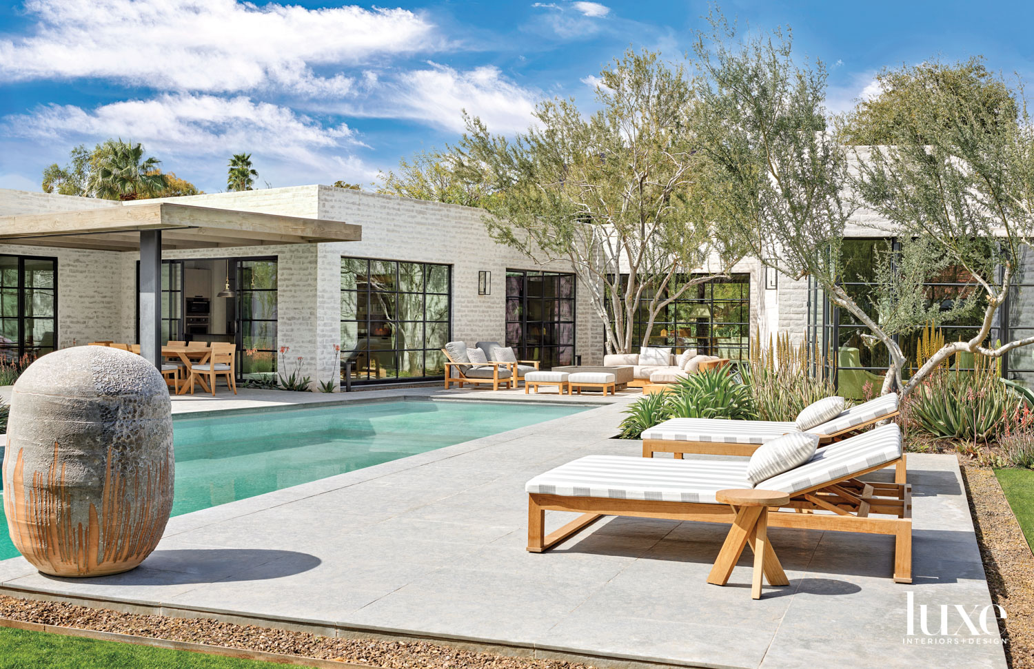 A poolside patio with gray-and-white...