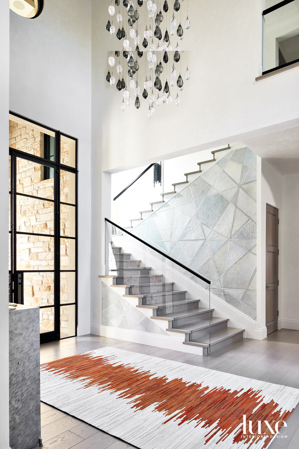 An entryway with a glass-railing...