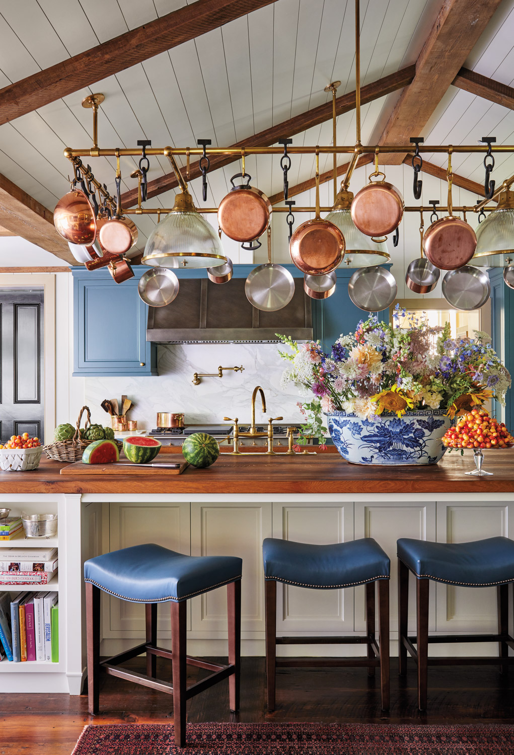 mayrland kitchen with blue cabinets and copper pots