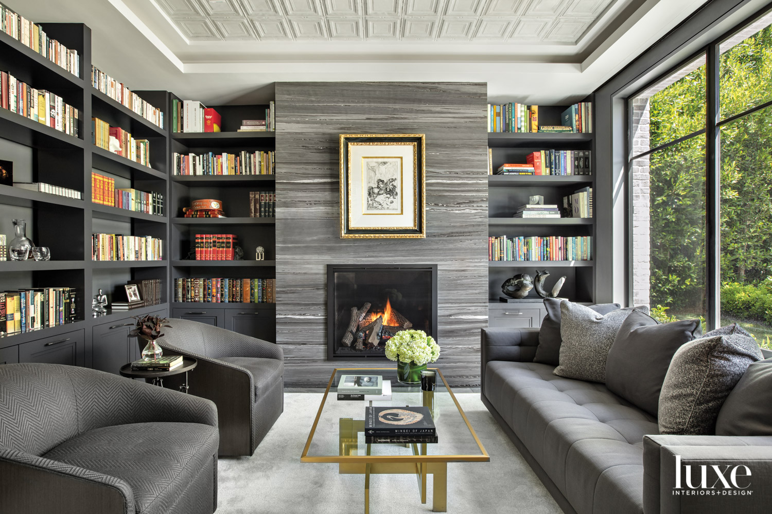 Library with gray marble fireplace,...