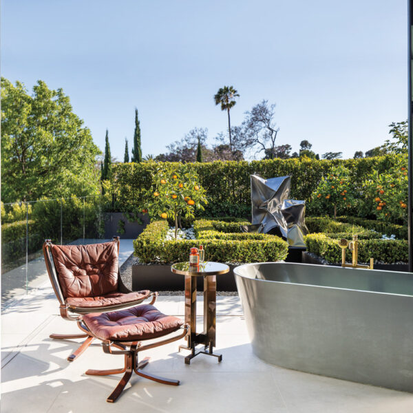 Get An Inside Look At Architect Richard Landry’s Own Los Angeles Home Modern bathroom with freestanding tub and garden view