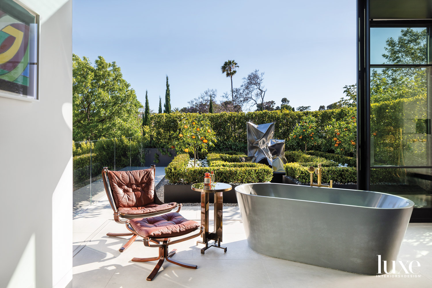 Modern bathroom with freestanding tub and outdoor view serve as perfect garden inspiration