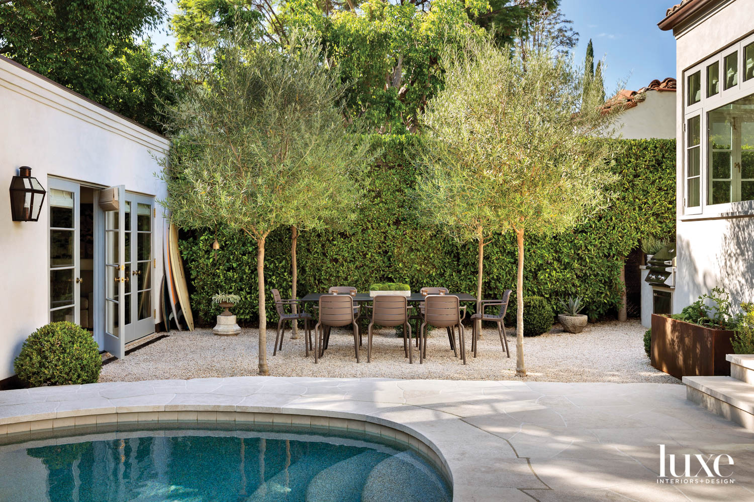 Garden featuring a pool, dinging table, chairs and olives trees