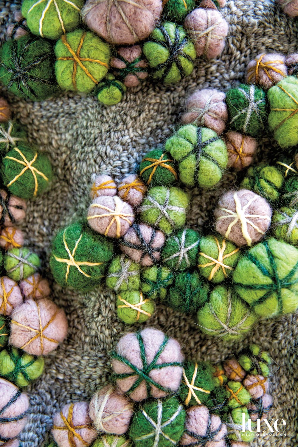 detail of fiber work featuring green and pink forms