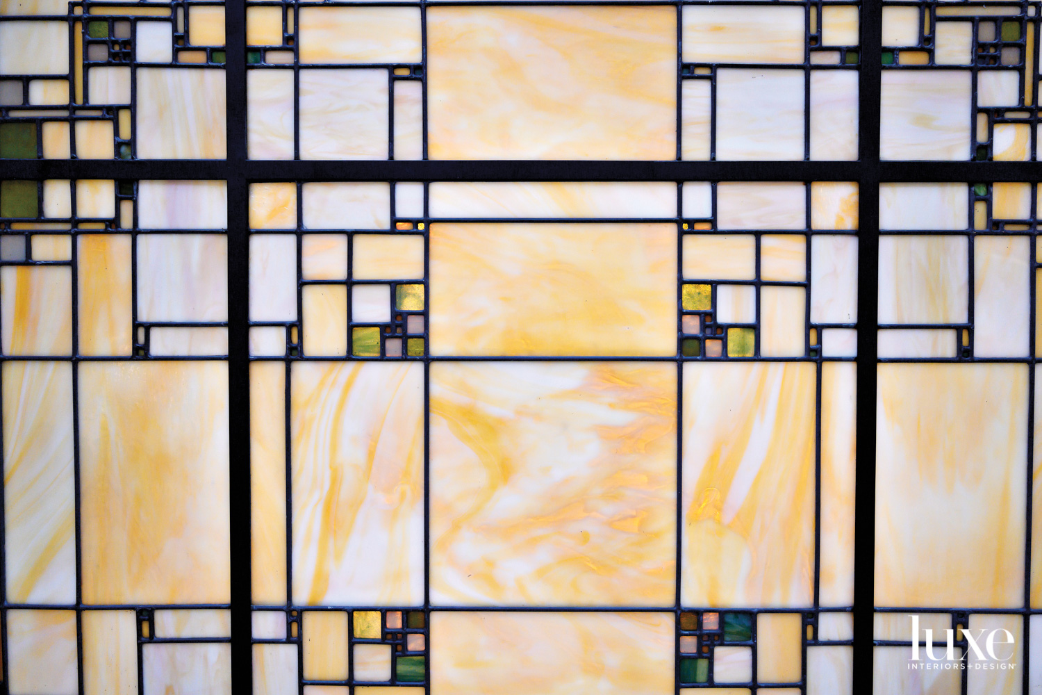 A stained glass window by Theodore Ellison displays a classic style.