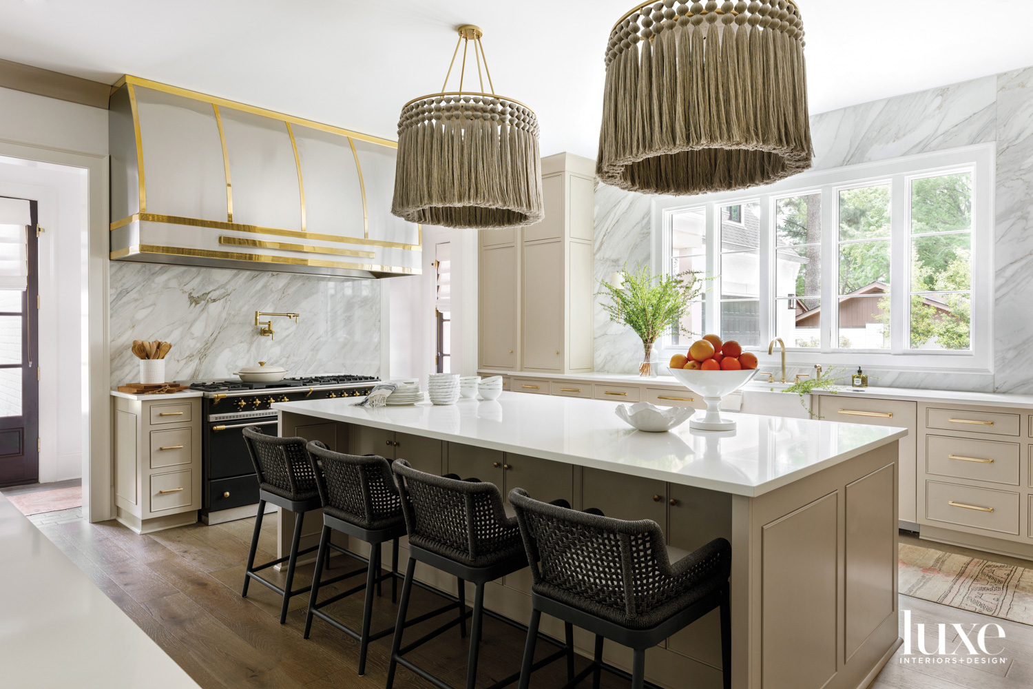 Kitchen with taupe cabinetry, brass...