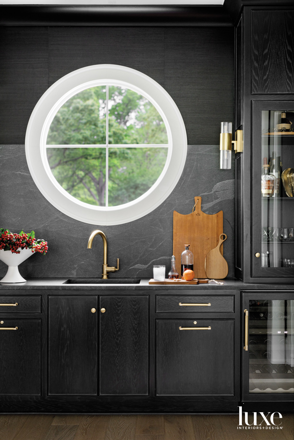 Wet bar with dark cabinetry...