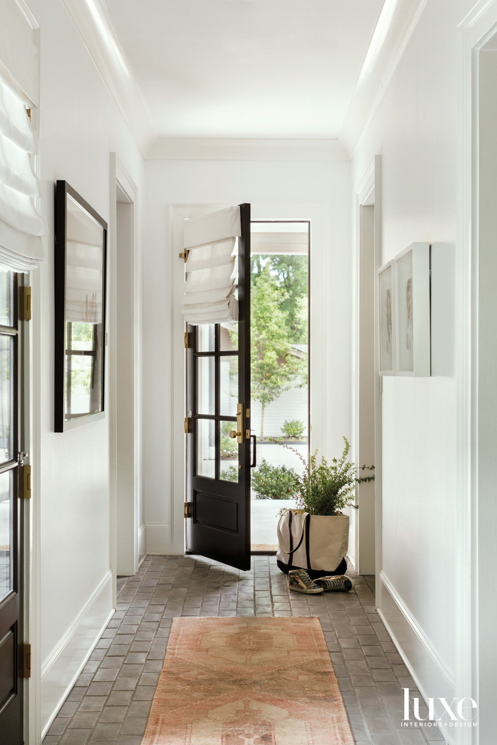 Hallway with white walls and...