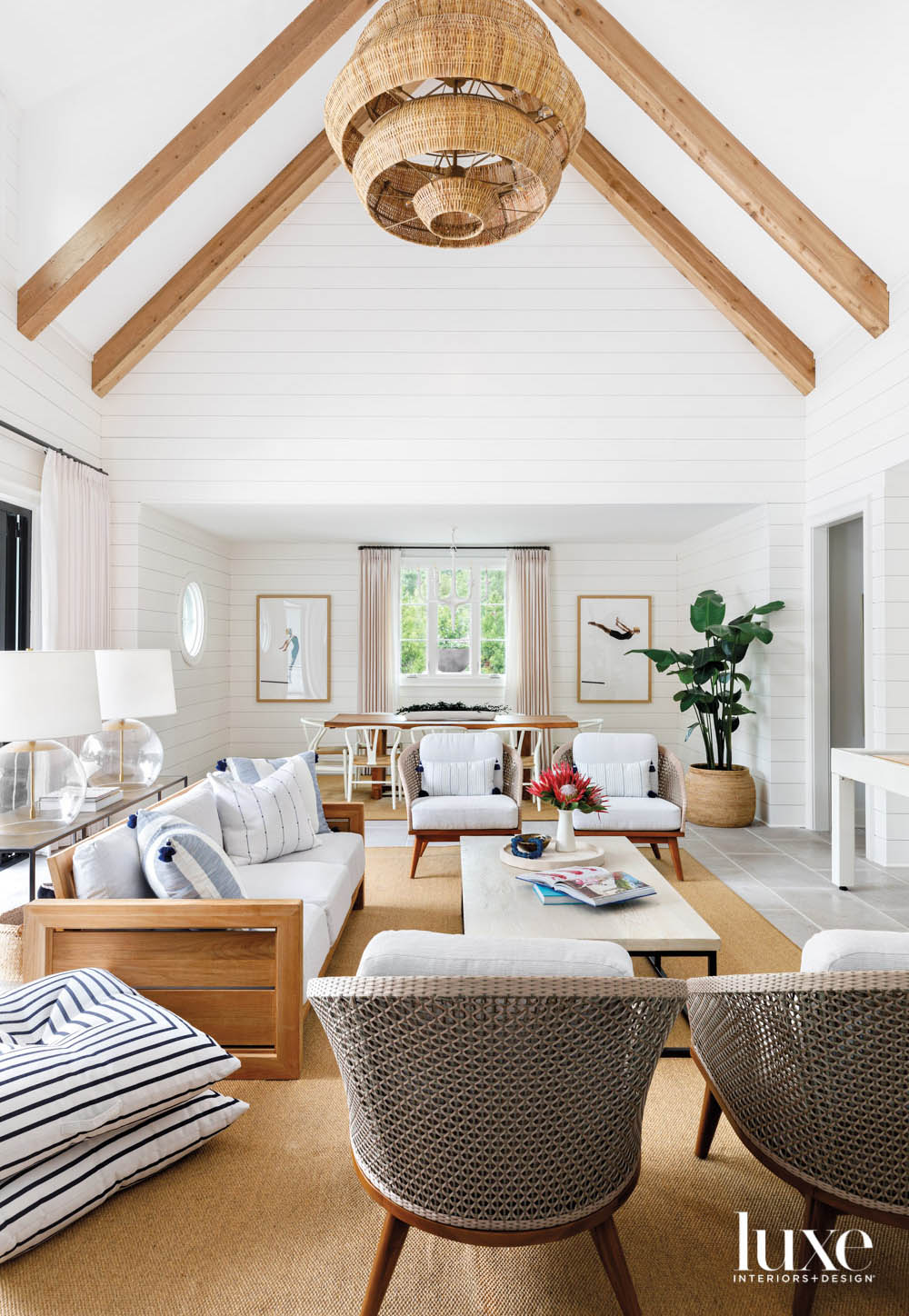 Large living room with white walls and vaulted ceiling