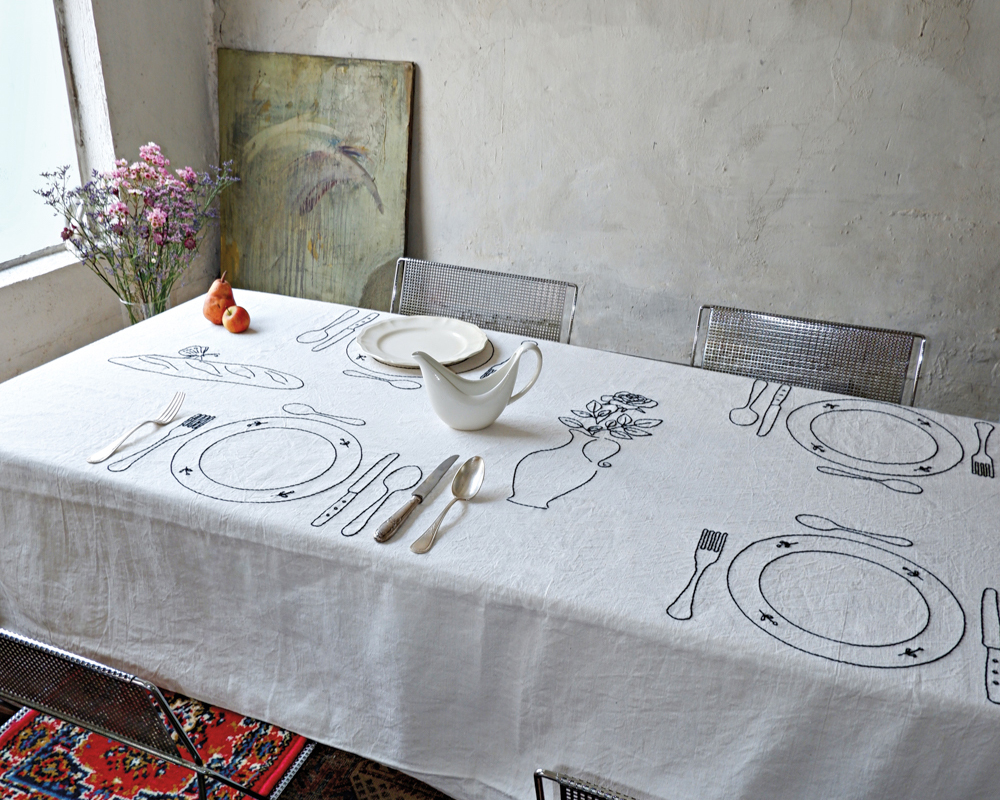 Sarah Espeute white embroidered table linens on dining table