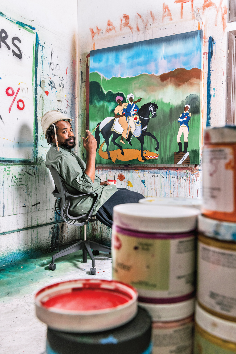 artist Umar raschid in his studio, holding a paintbrush
