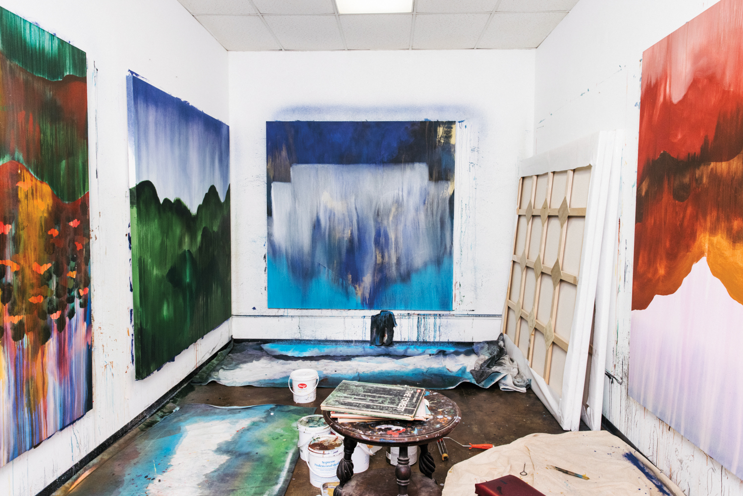 a view of Los Angeles artist umar Rashid's studio with several canvases on the walls