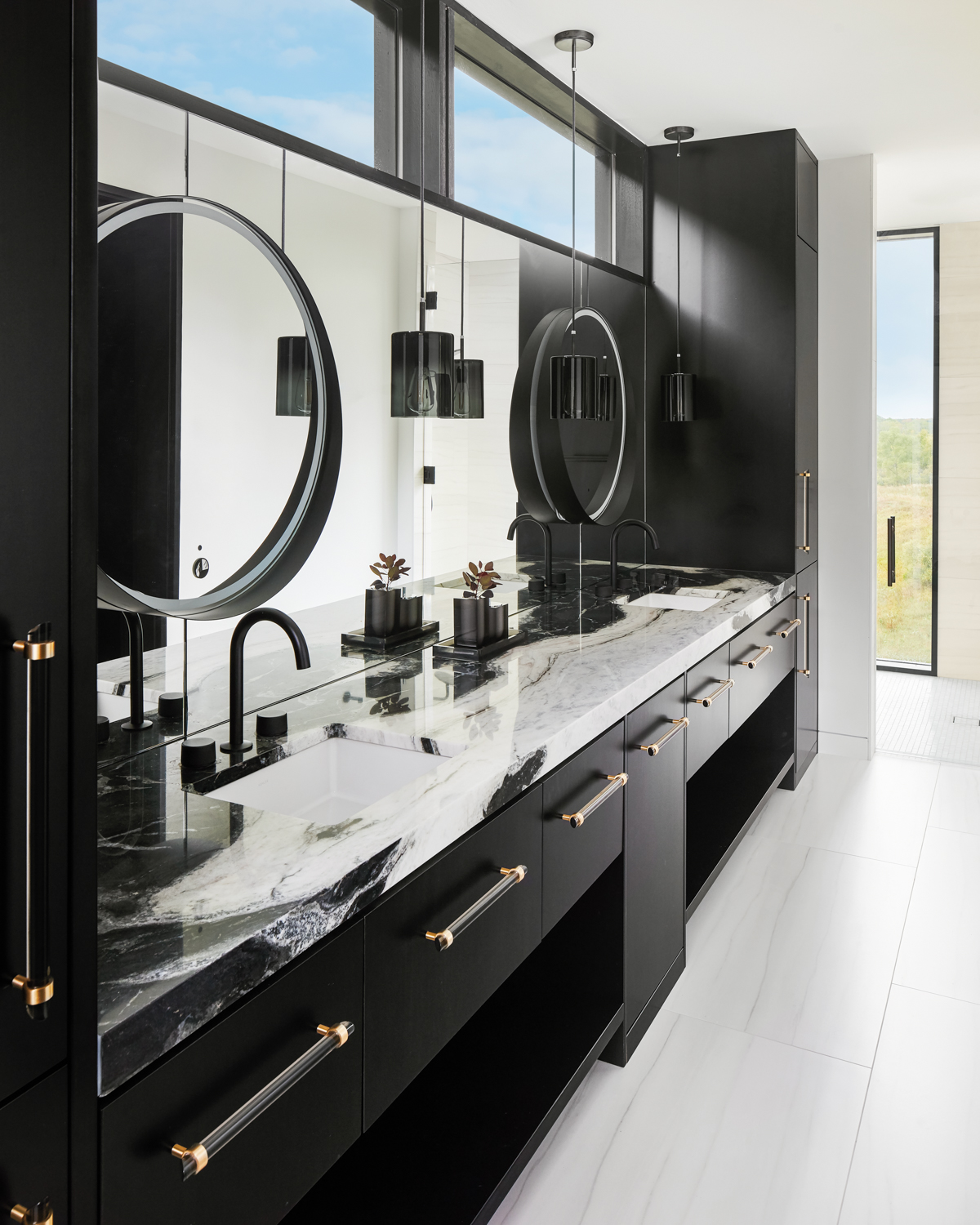 A bathroom with black cabinetry...