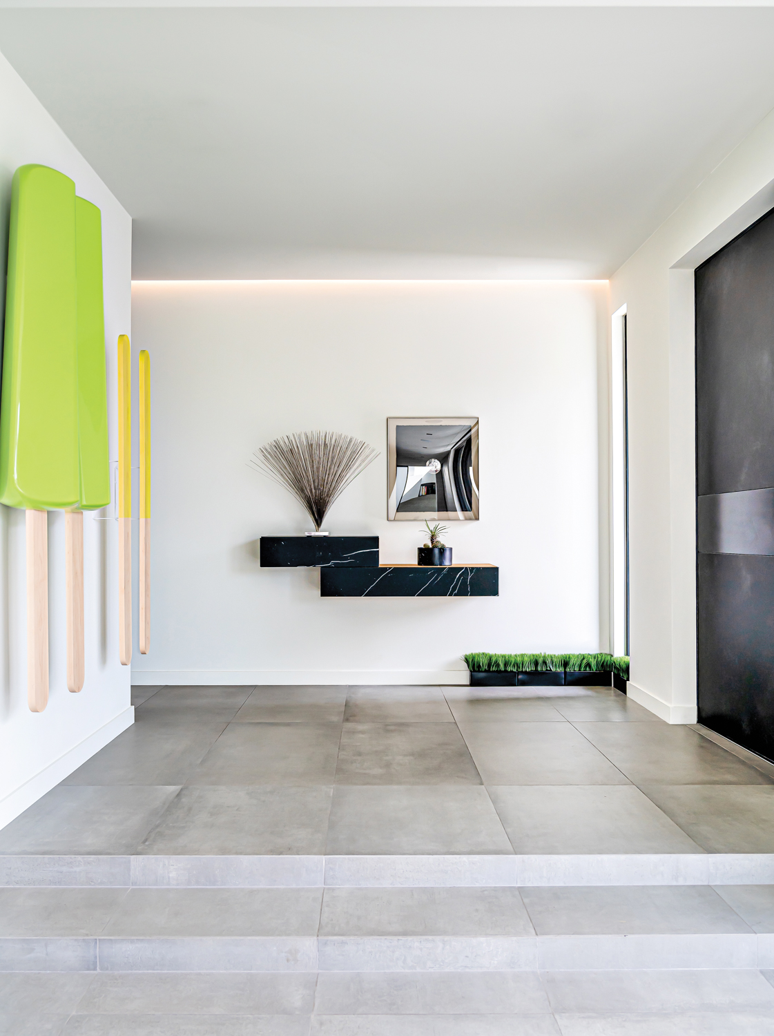 foyer with white walls, green...