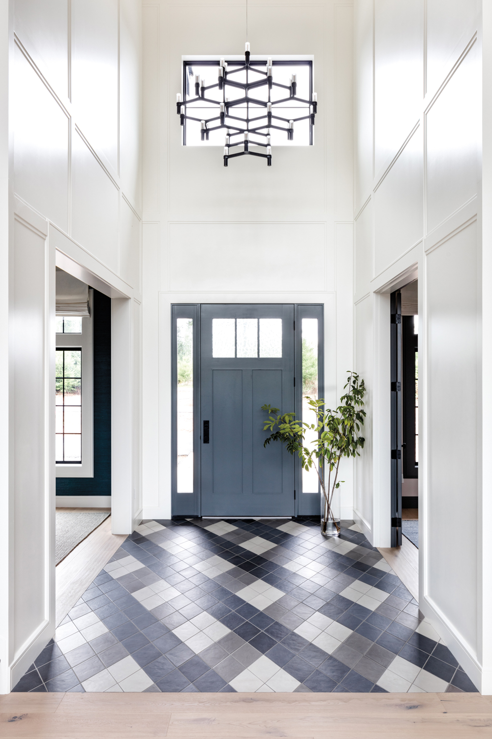 entryway with tartan pattern tiles and Nemo lighting fixture