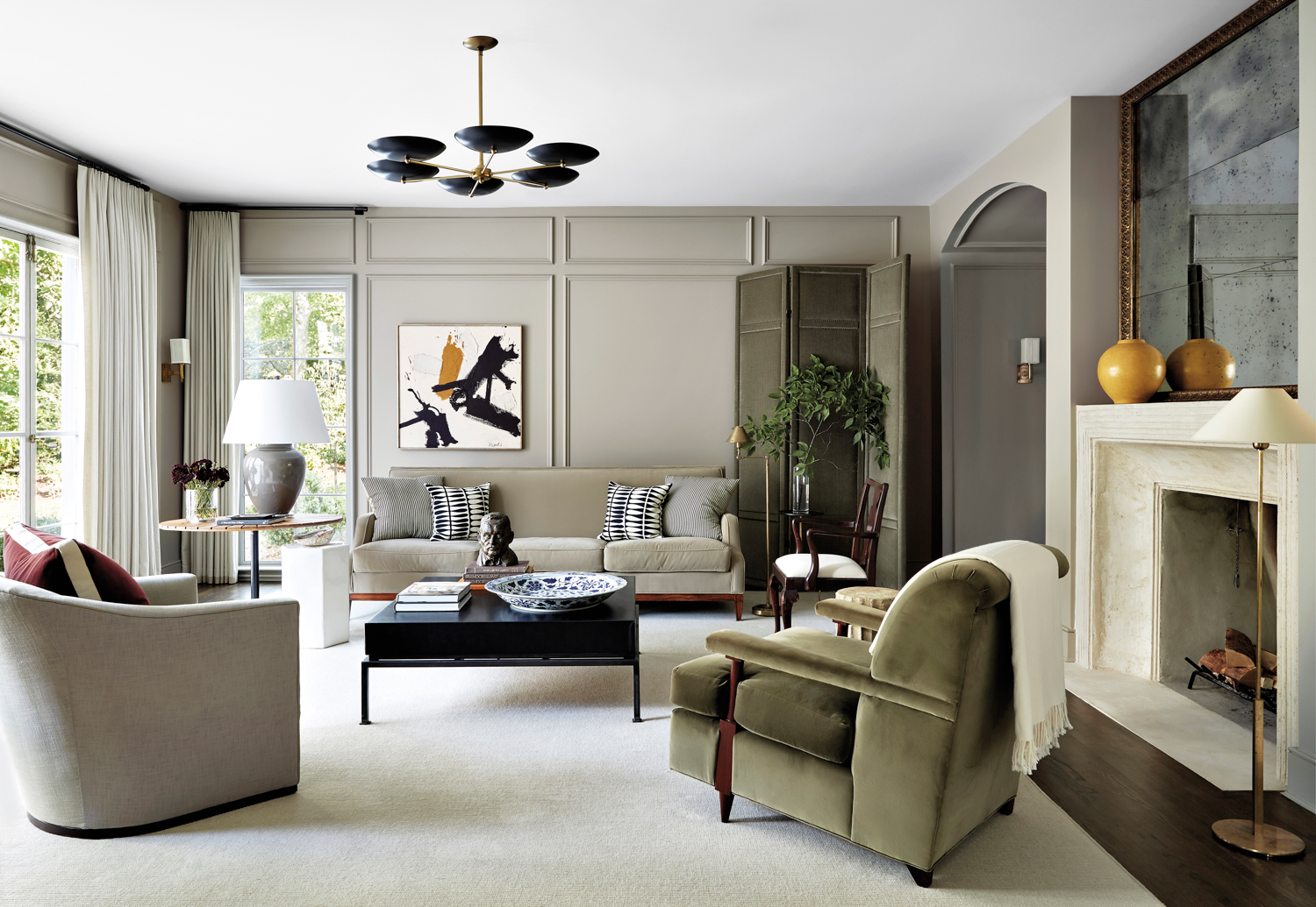 Soft gray living room with velvet upholstery, modern lighting and abstract art