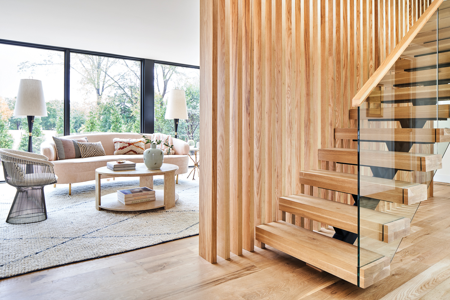 Sitting room divided from staircase by modern slatted screen
