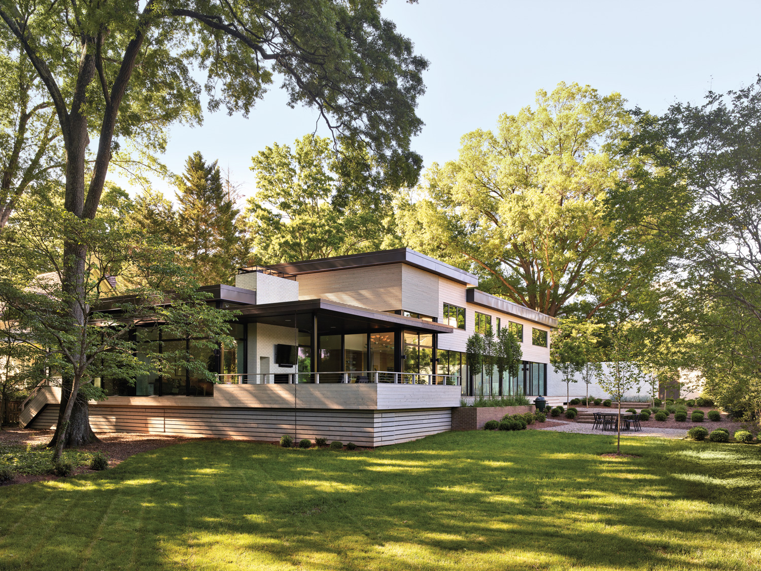 Midcentury modern house with large lawn and mature trees