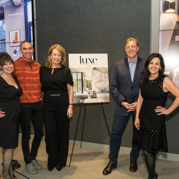 High/Low: Unglamorous Tales from Luxury panelists posing by Luxe sign