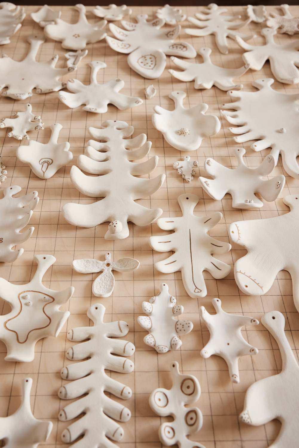 Porcelain leaves laying on a wooden panel.