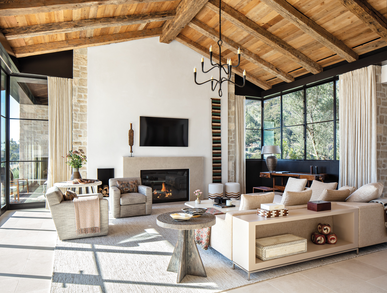 living room with white sectional incorporating a console table, with coffee table and swivel chairs
