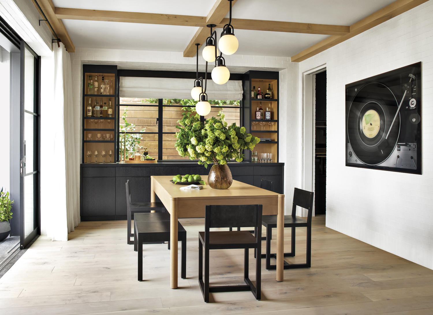 dining room with custom oak table surrounded by BDDW chairs and a bench, backed by built in buffet
