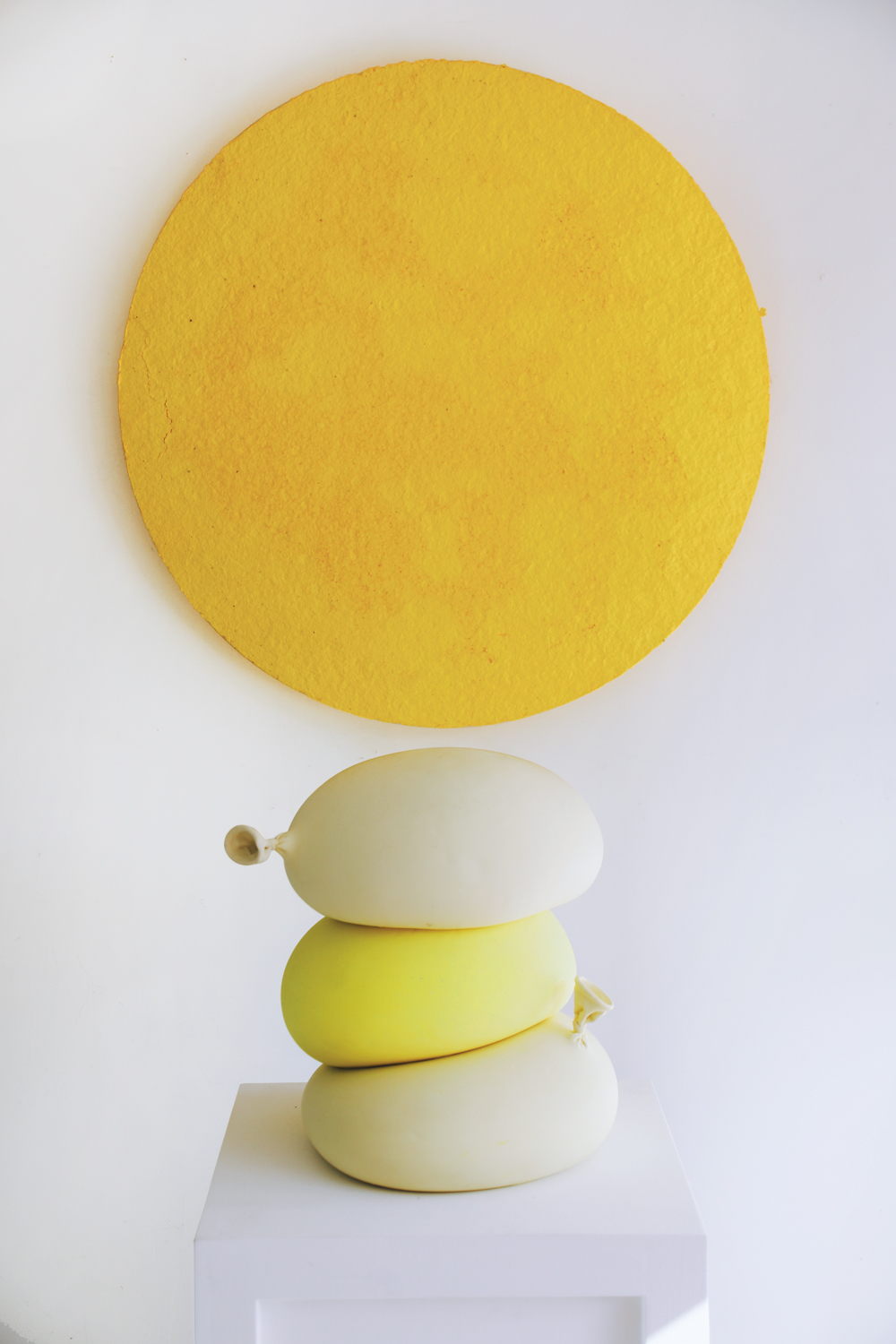 stack of yellow and white balloons in porcelain statue