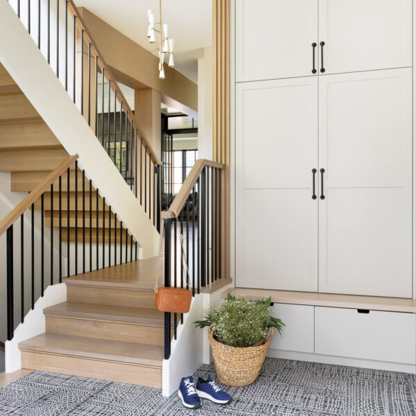 L.A. Style Sets The Stage For A Chicago Couple’s Dream Home A mudroom with ivory cabinetry. Off of it is a staircase that leads into the rest of the house.