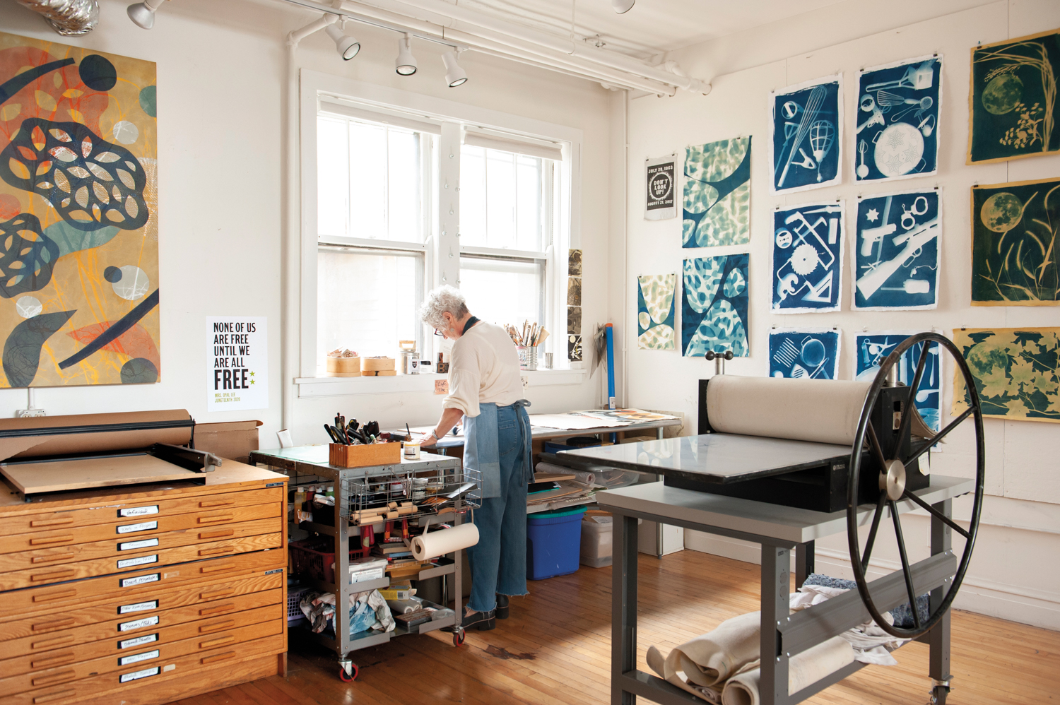 A woman at work in a print studio.