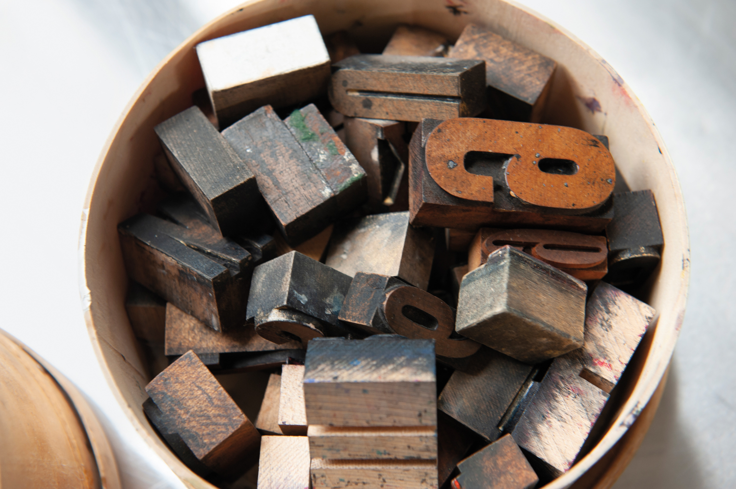 A bucket filled with letter blocks.