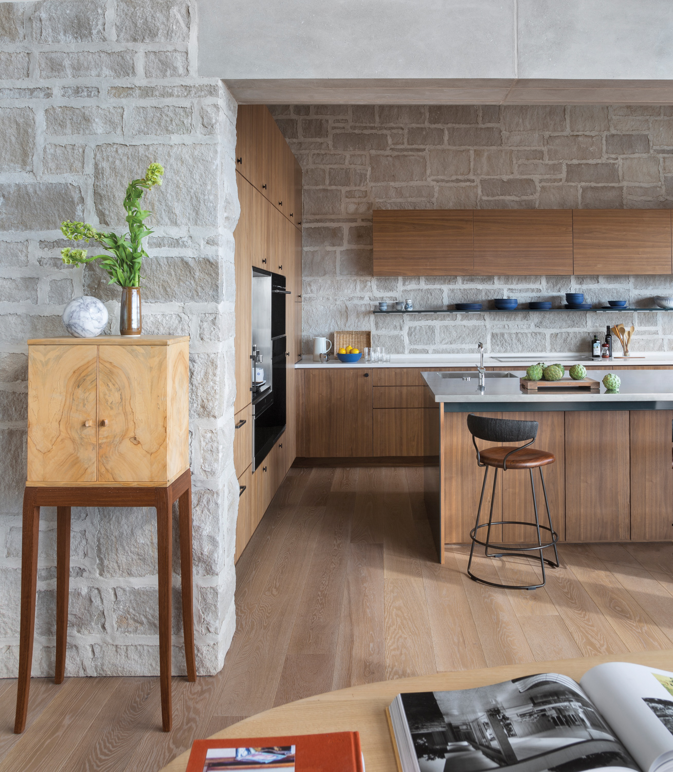 walnut kitchen with stone walls,...