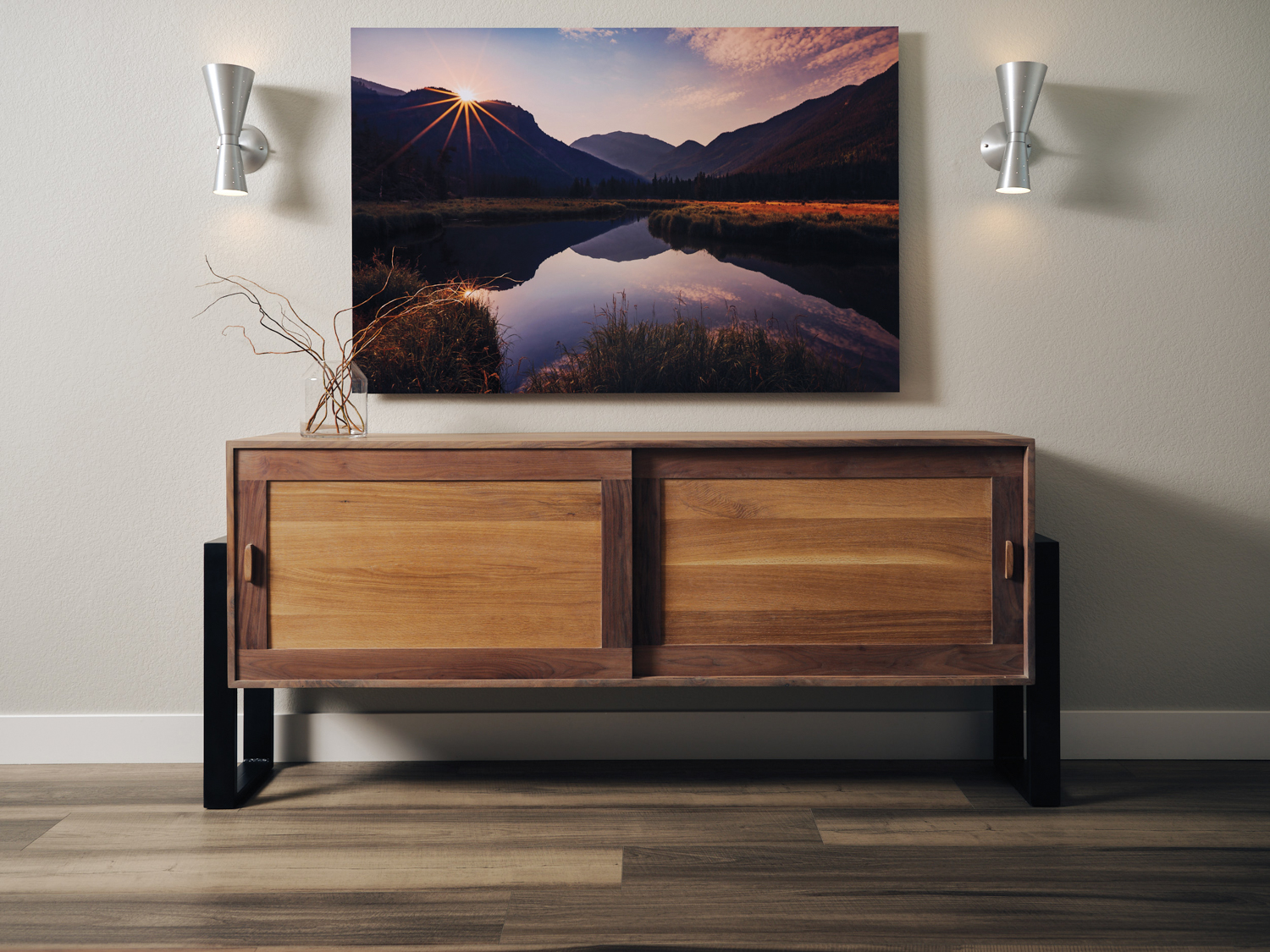 landscape photograph hanging over wooden credenza