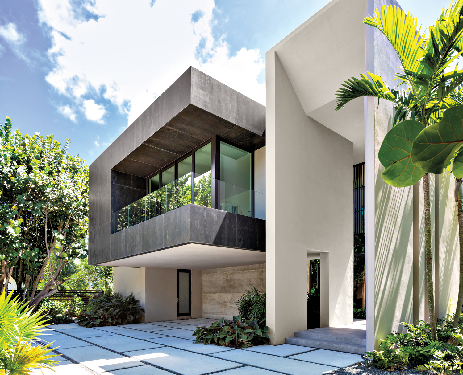 exterior of contemporary Miami home with cantilevered forms of stucco, glass and ipe wood