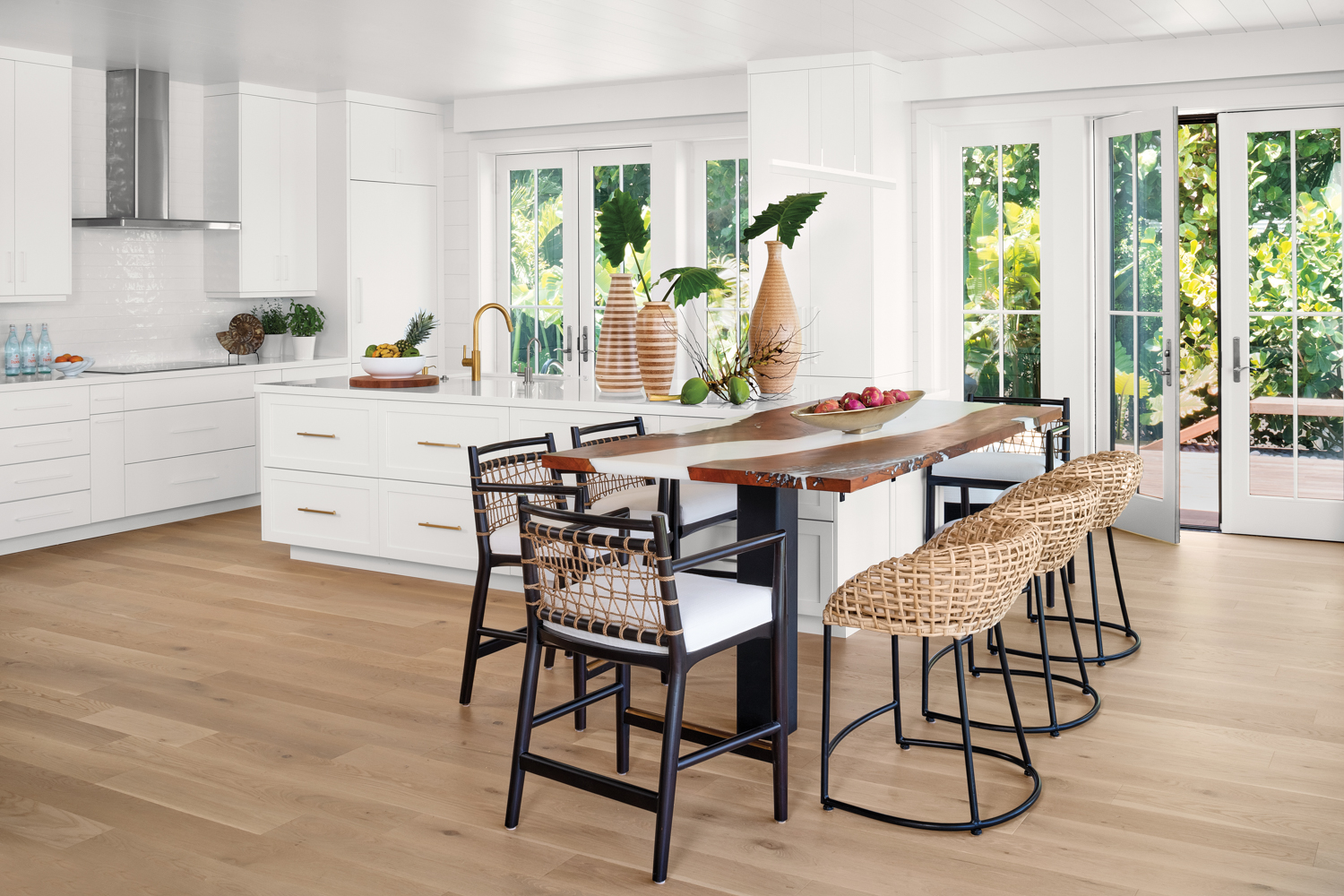 kitchen with white walls and cabinetry, wood flooring, a live-edge table connected to the countertop and two sets of counter stools