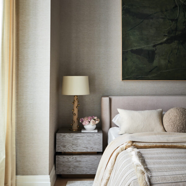 Lean Into The Posh Palette Of Neutrals Of This Tribeca Pied-à-Terre bedroom with linen wallcoverings and bed next to carlyle collective nightstand