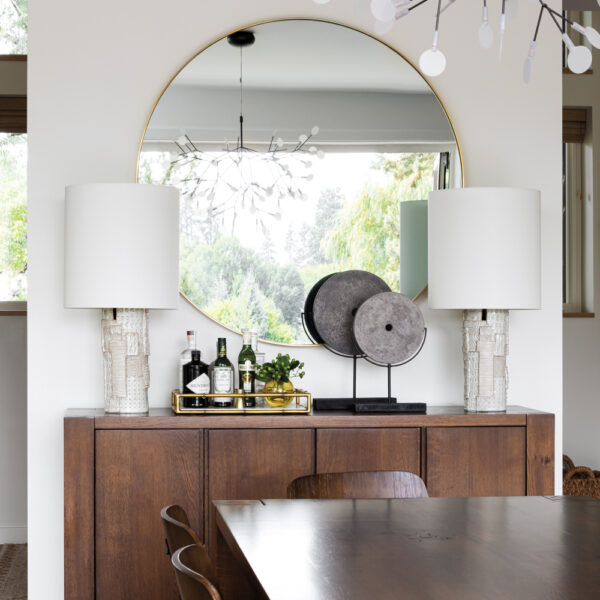 See How Classic Cottages Inspired This Modern Oregon Home modern dining room console holds oversized round mirror