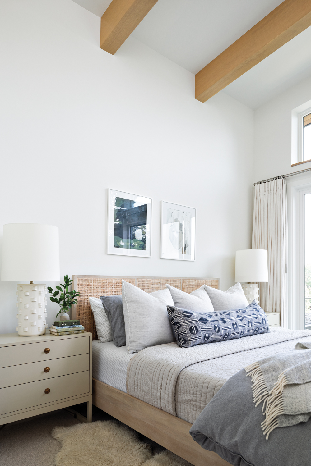 modern bedroom features shades of white, blue and gray