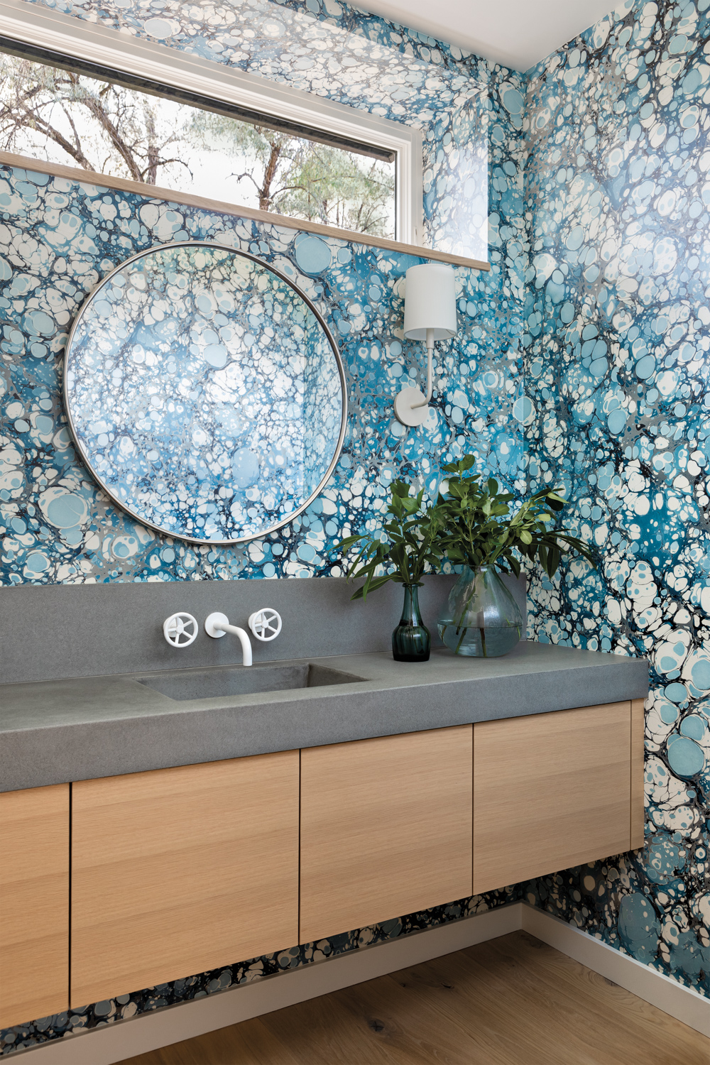 modern powder room features a boldly patterned wall covering
