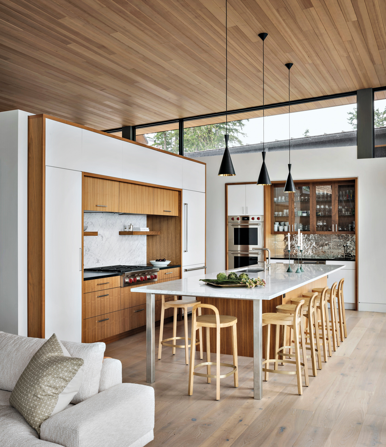 Light-colored wood and white marble make up the kitchen.