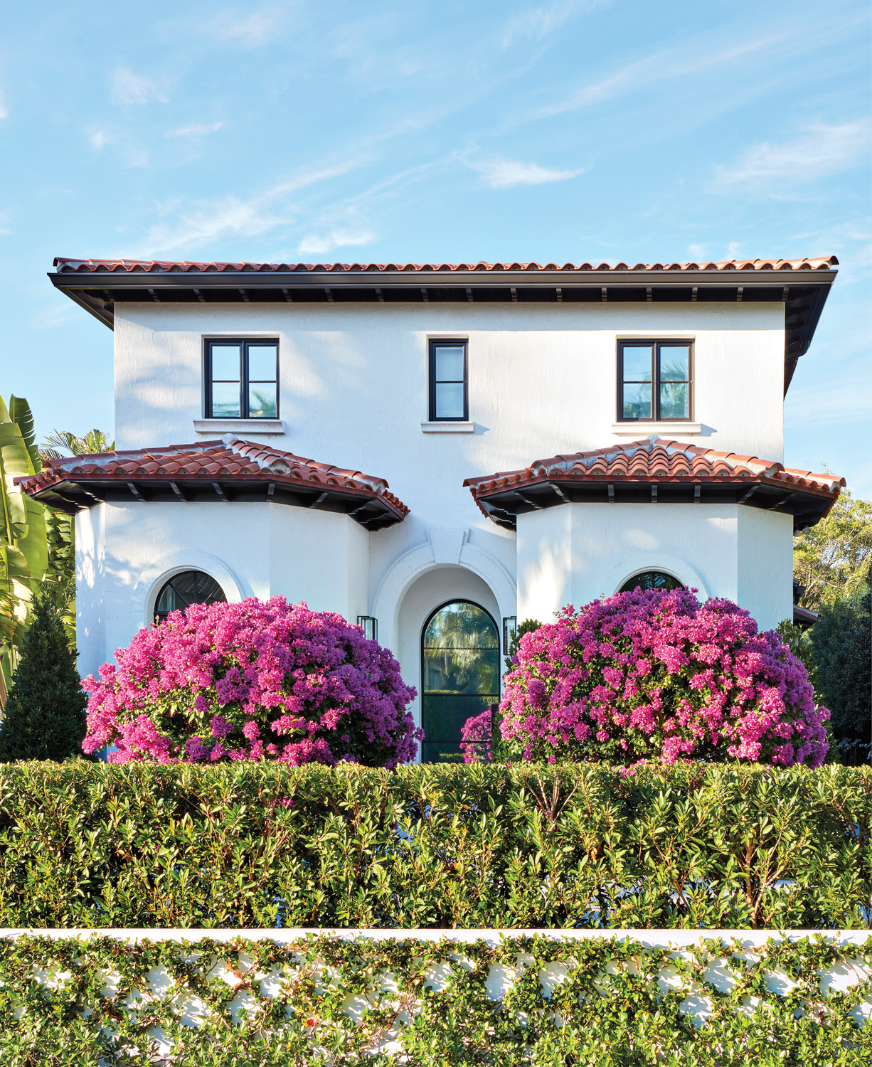 old world facade palm beach home with bougainvillea